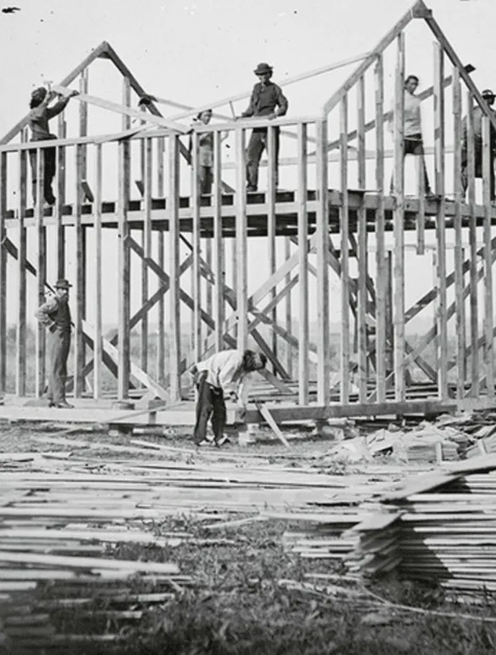 Traditional framing crew prior to the widespread use of pneumatic nailers